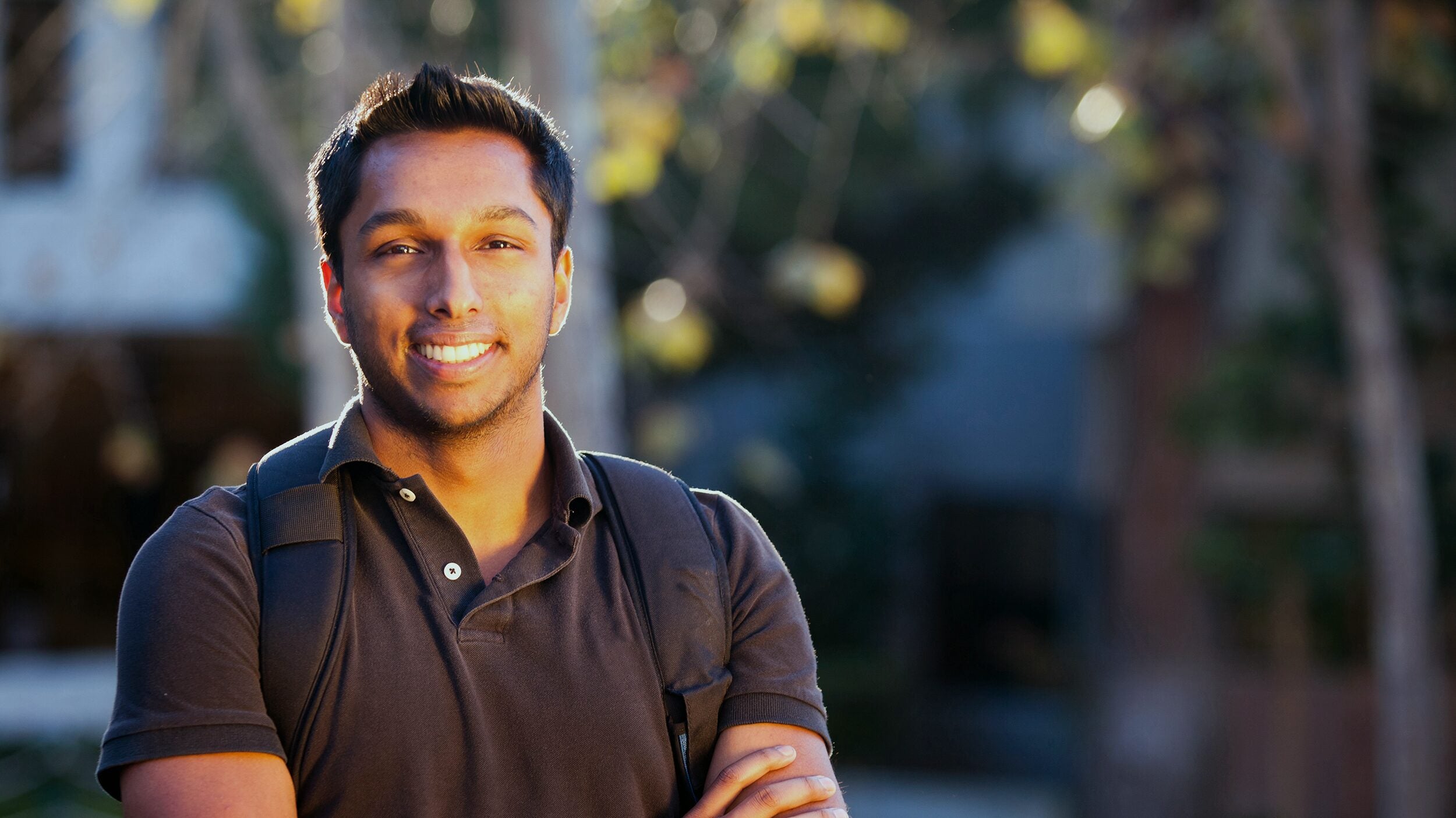 Student with a backpack, outside the University.
